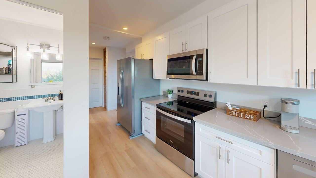 Kitchen appliances, countertops, and coffee station